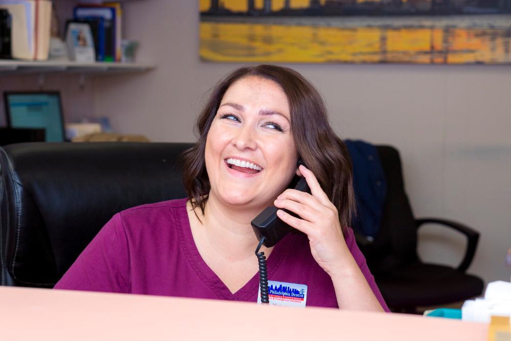 Front desk staff at The Philadelphia Dentist answering phone