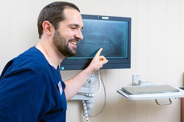 Dentist pointing at xray in Philadelphia 