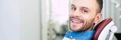 A patient smiling after tooth extraction at the Philadelphia Dentist