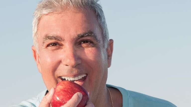 A man eating an apple in Philadelphia, PA