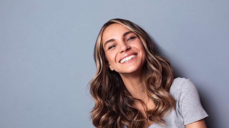 A woman smiling after a Dental Implants consultation in Northeast Philadelphia