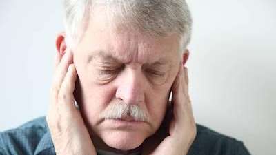 A Man holding his jaw in pain due to a toothache at the Philadelphia Dentist