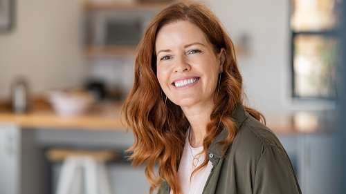 A woman smiling after getting Porcelain Veneers in Greater Philadelphia Area