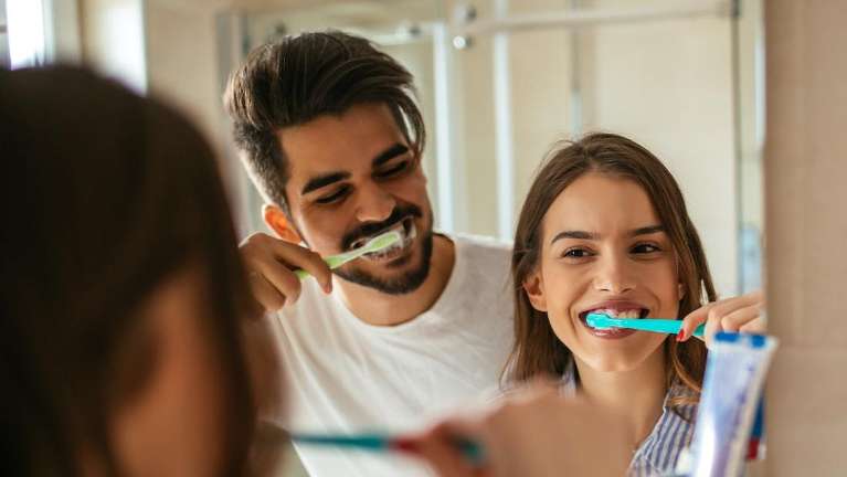 A couple brushing teeth in Philadelphia, PA