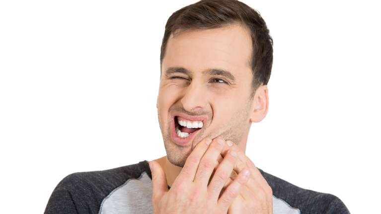A patient with root canal holding his jaw in pain in Philadelphia, PA