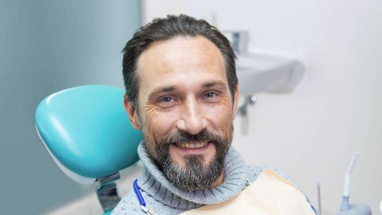 Man smiling before tooth extraction procedure in Philadelphia, PA