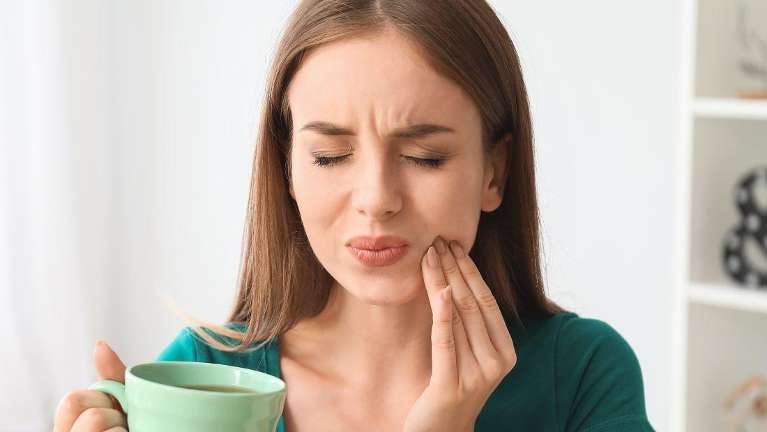 A lady holding her jaws due to migraines in Philadelphia, PA