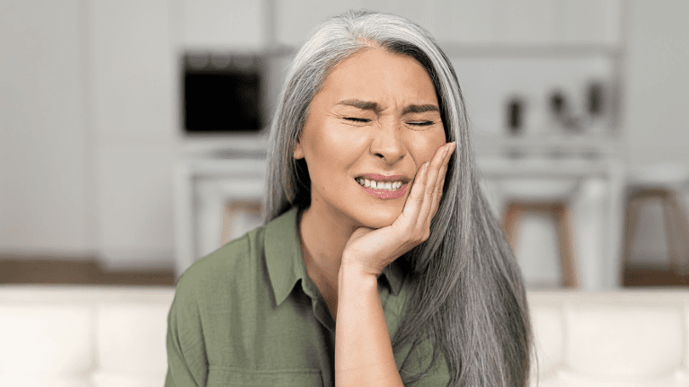 A lady holding her jaws due to tooth pain in Philadelphia, PA