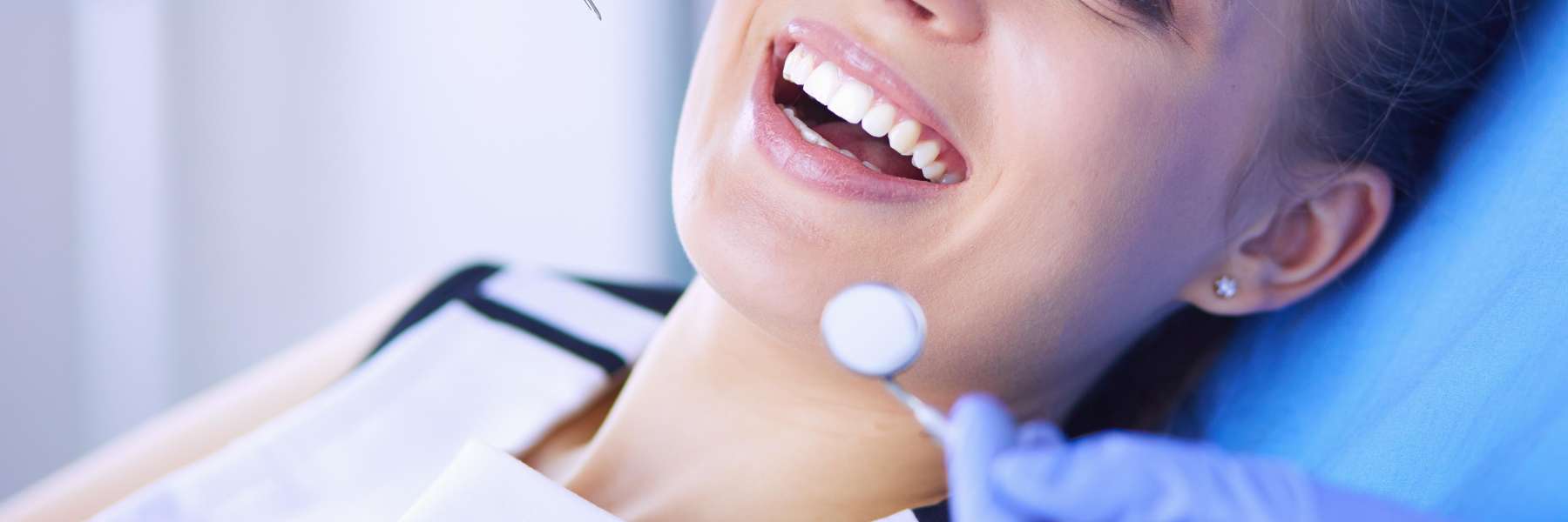 A client smiling while getting dental veneers at the Philadelphia Dentist