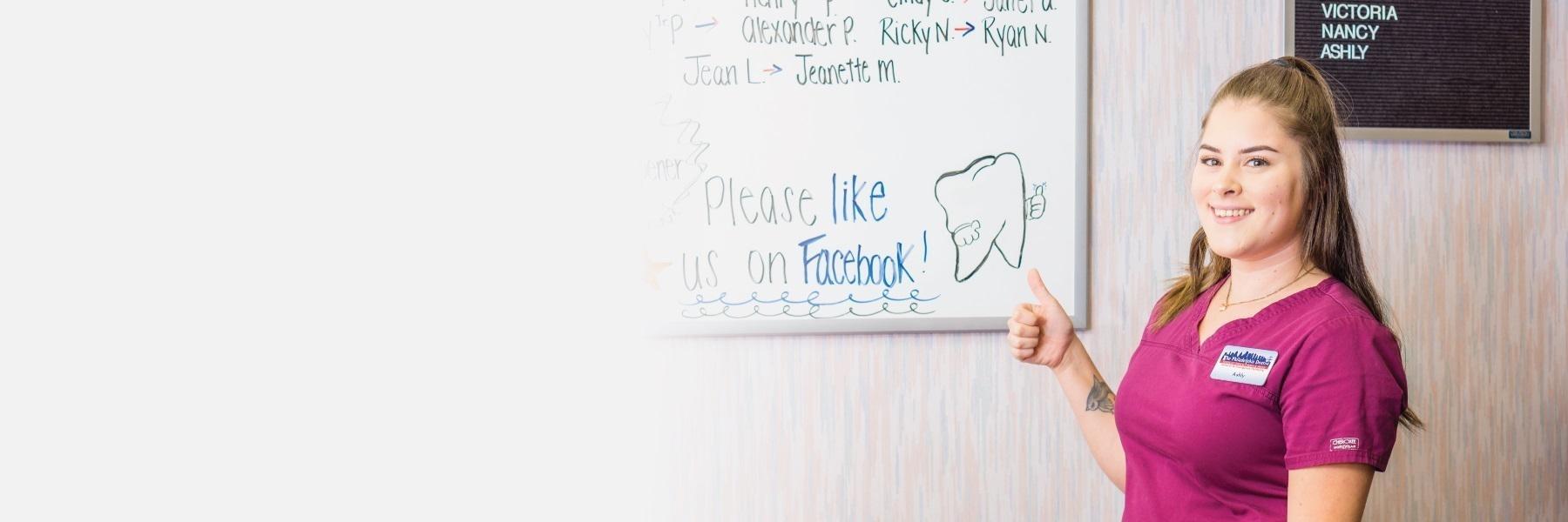 Staff member standing near white board at The Philadelphia Dentist