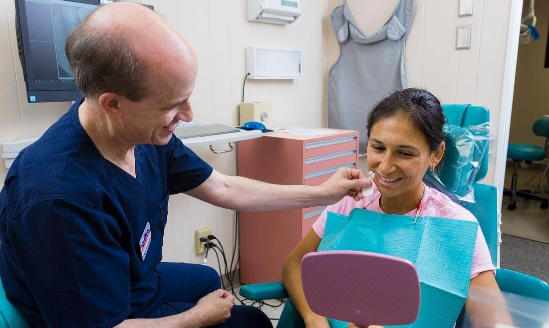 Dr. Schriftman checks patient's smile